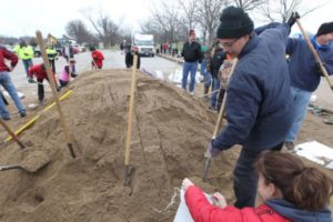 Volunteers fill sandbags that will used to create a wall along the River Des Peres in St. Louis on December 29, 2015. Statewide, thirteen people have died due to flooding that may equal or surpass the Great Flood of 1993. Over 250 roads have been closed to to water over the roadways. Photo by Bill Greenblatt/UPI
